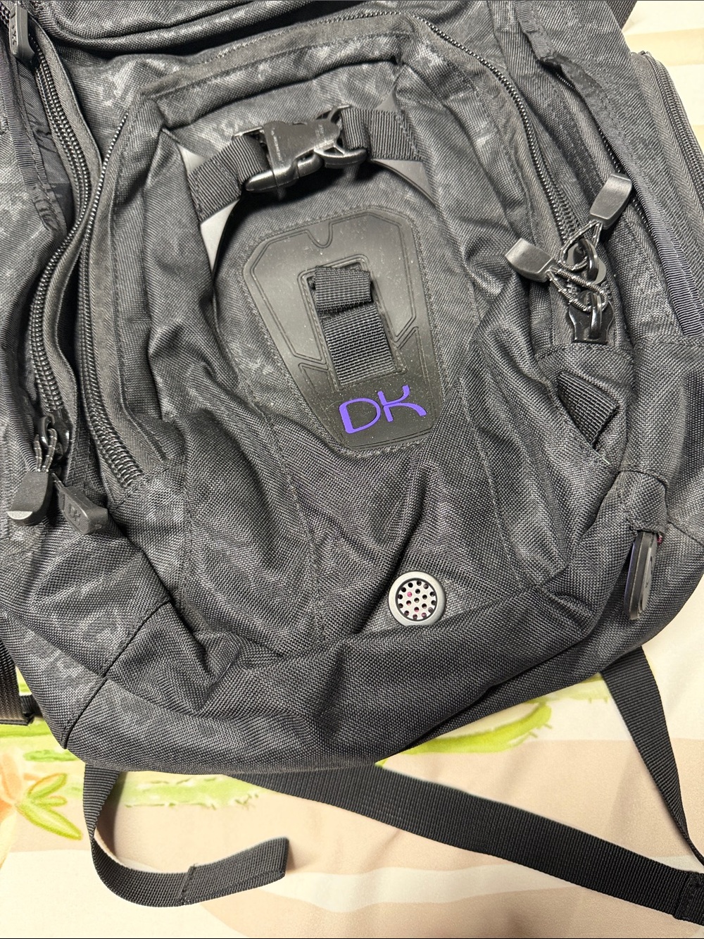 Dakine Heli Pro backpack features a black camouflage pattern and purple brandin - Picture 3 of 6